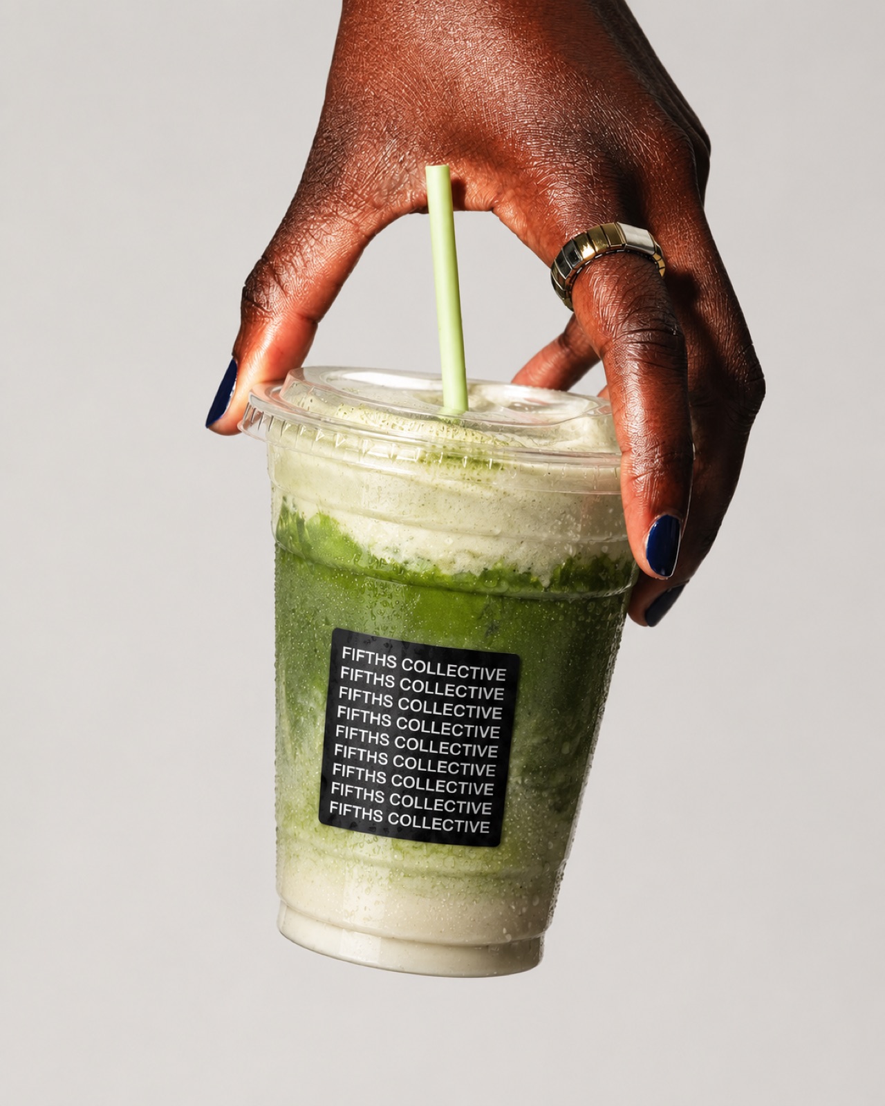 A blended Fifths Collective matcha held up by its lid