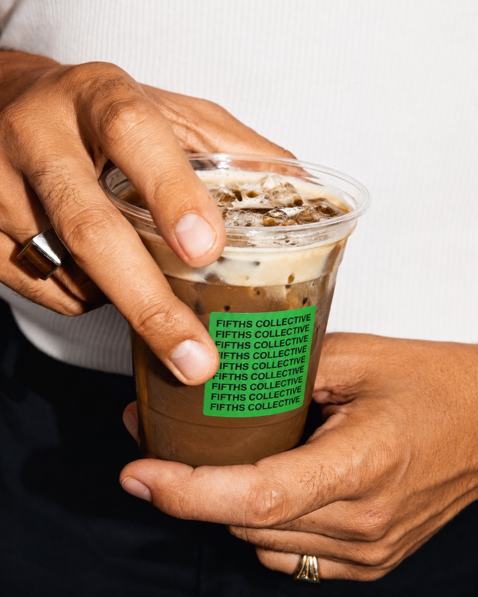 An iced Fifths Collective drink held in both hands